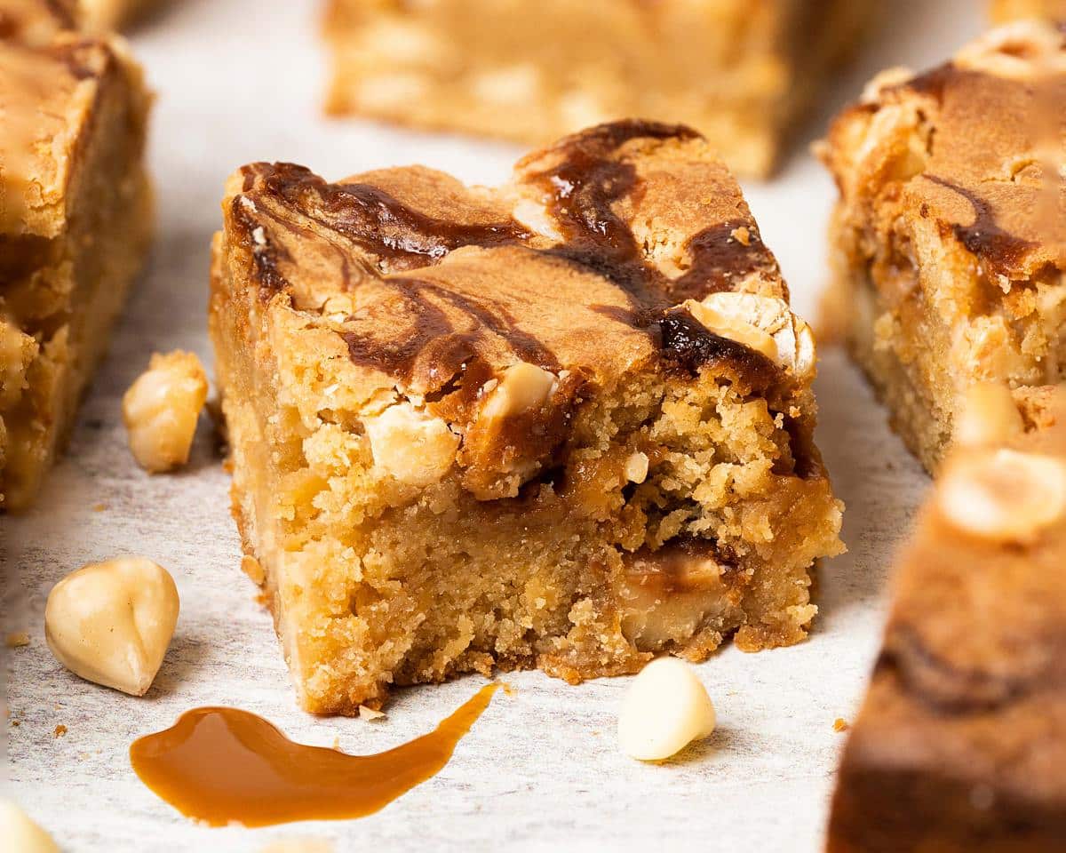 Salted caramel blondies. Soft and fudgy blondies packed with salted caramel, white chocolate chips and hazelnut halves make a delicious mix of flavours and textures! Recipe by movers and bakers