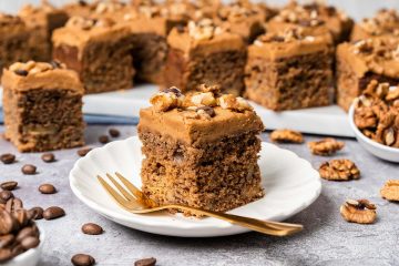 My coffee and walnut traybake is an incredibly moreish bake, with a light and fluffy coffee sponge cake dotted with walnuts throughout, topped with a silky coffee buttercream and decorated with more walnuts and coffee beans. Perfect for feeding a crowd! Recipe by movers and bakers