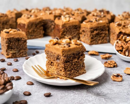 My coffee and walnut traybake is an incredibly moreish bake, with a light and fluffy coffee sponge cake dotted with walnuts throughout, topped with a silky coffee buttercream and decorated with more walnuts and coffee beans. Perfect for feeding a crowd! Recipe by movers and bakers
