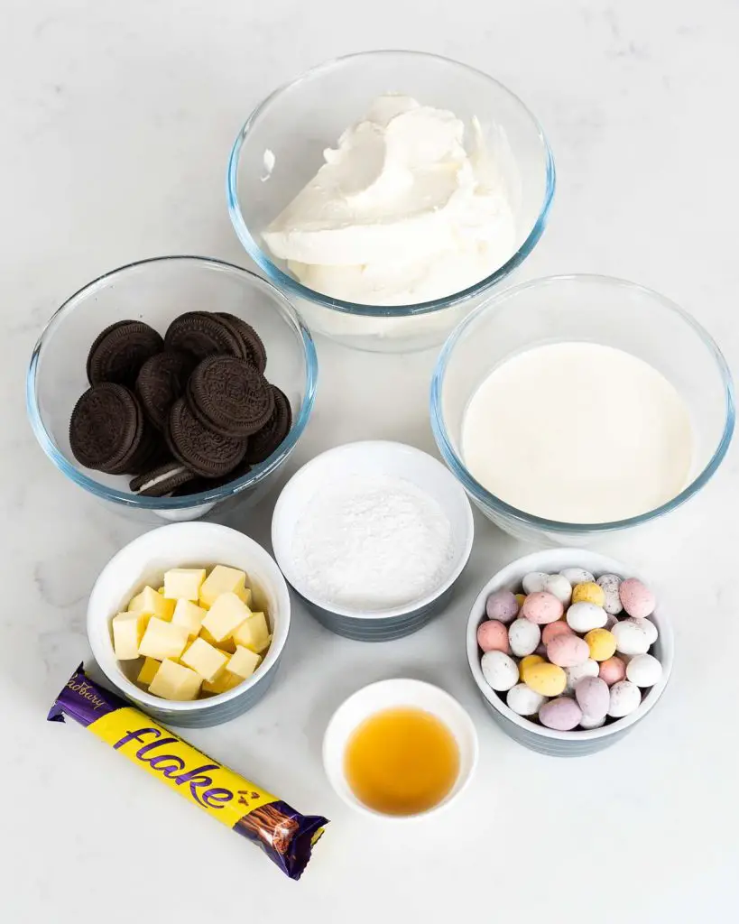 Ingredients required: oreo cookies, unsalted butter, cream cheese, icing (powdered) sugar, vanilla, double (heavy) cream, chocolate flakes and mini eggs. Recipe by movers and bakers