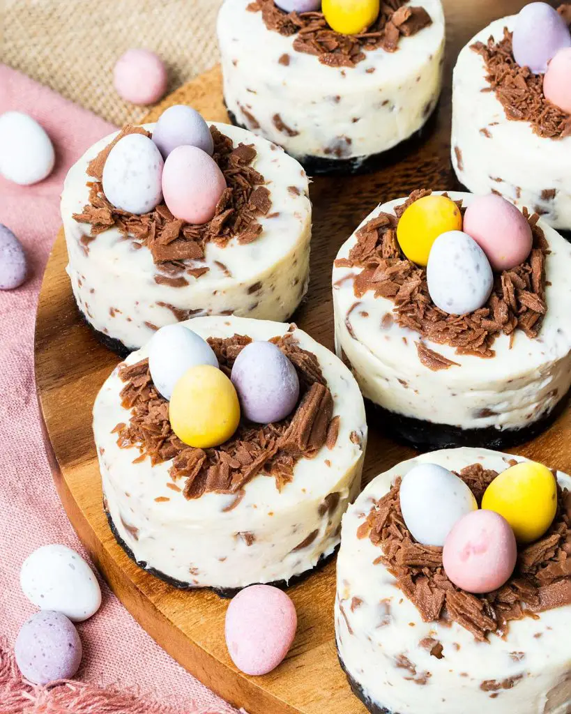 My mini egg cheesecakes are perfectly adorable, individual cheesecakes with a chocolate biscuit base, a creamy cheesecake filling packed with mini eggs, and a chocolate nest with even more mini eggs to decorate. Heavenly! Recipe by movers and bakers