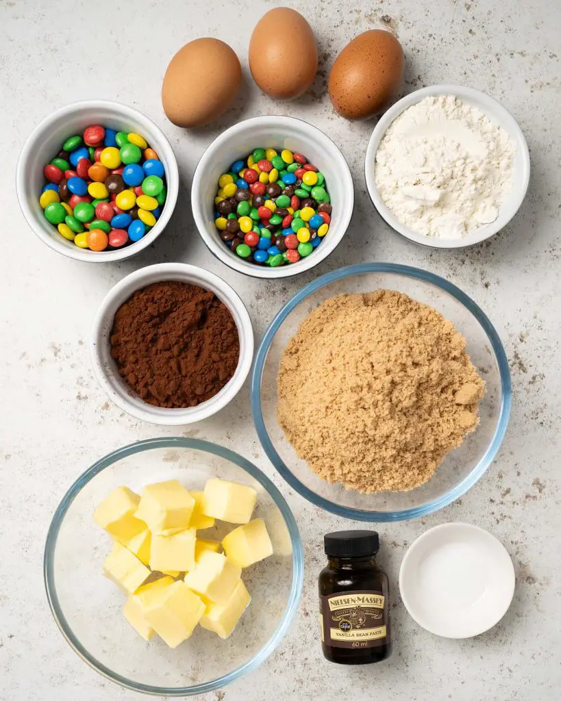 Ingredients required: unsalted butter, cocoa powder, brown sugar, eggs, plain (all purpose) flour, salt, vanilla and M&Ms. Recipe by movers and bakers