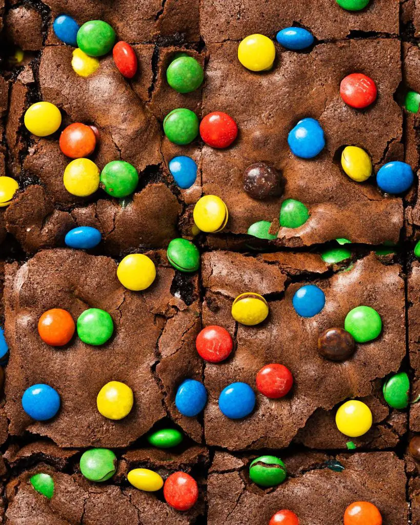 My M&M brownies are chunky and chewy and perfectly decadent, packed with plenty of M&Ms inside and on top. A perfect, fun brownie treat! Recipe by movers and bakers