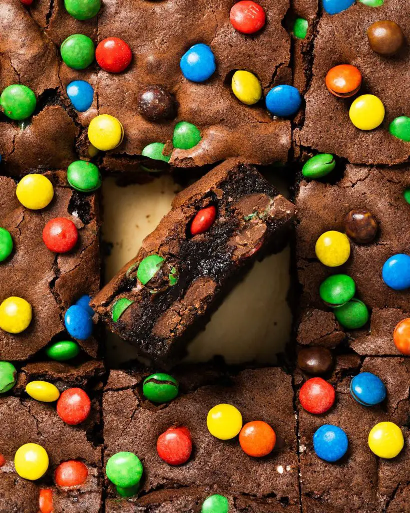 My M&M brownies are chunky and chewy and perfectly decadent, packed with plenty of M&Ms inside and on top. A perfect, fun brownie treat! Recipe by movers and bakers