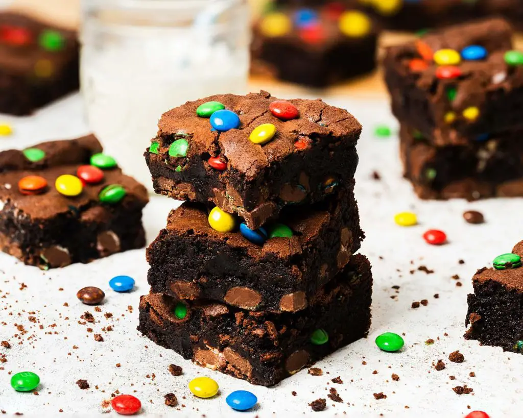 My M&M brownies are chunky and chewy and perfectly decadent, packed with plenty of M&Ms inside and on top. A perfect, fun brownie treat! Recipe by movers and bakers