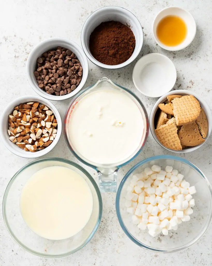 Ingredients required: double (heavy) cream, condensed milk, vanilla, salt, cocoa powder, chocolate chips, mini marshmallows, digestive biscuits and almonds. Recipe by movers and bakers