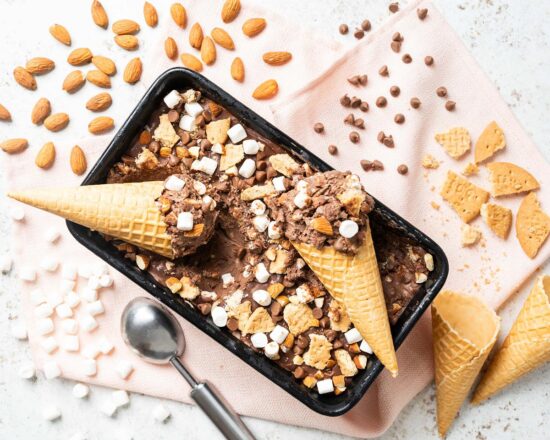 My homemade rocky road ice cream is a deliciously creamy chocolate ice cream packed with plenty of chocolate chips, mini marshmallows, digestive biscuit pieces and chopped almonds for amazing flavour and texture in every bite! Recipe by movers and bakers