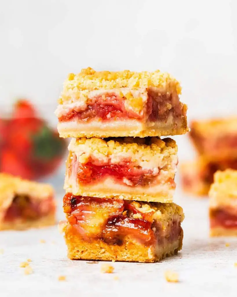 My strawberry rhubarb crumble bars are so incredibly delicious and moreish! A buttery shortbread mixture forms the base and crumble topping, encasing a tart, sweet and vibrant strawberry rhubarb filling. Bake to golden perfection and enjoy! Recipe by movers and bakers