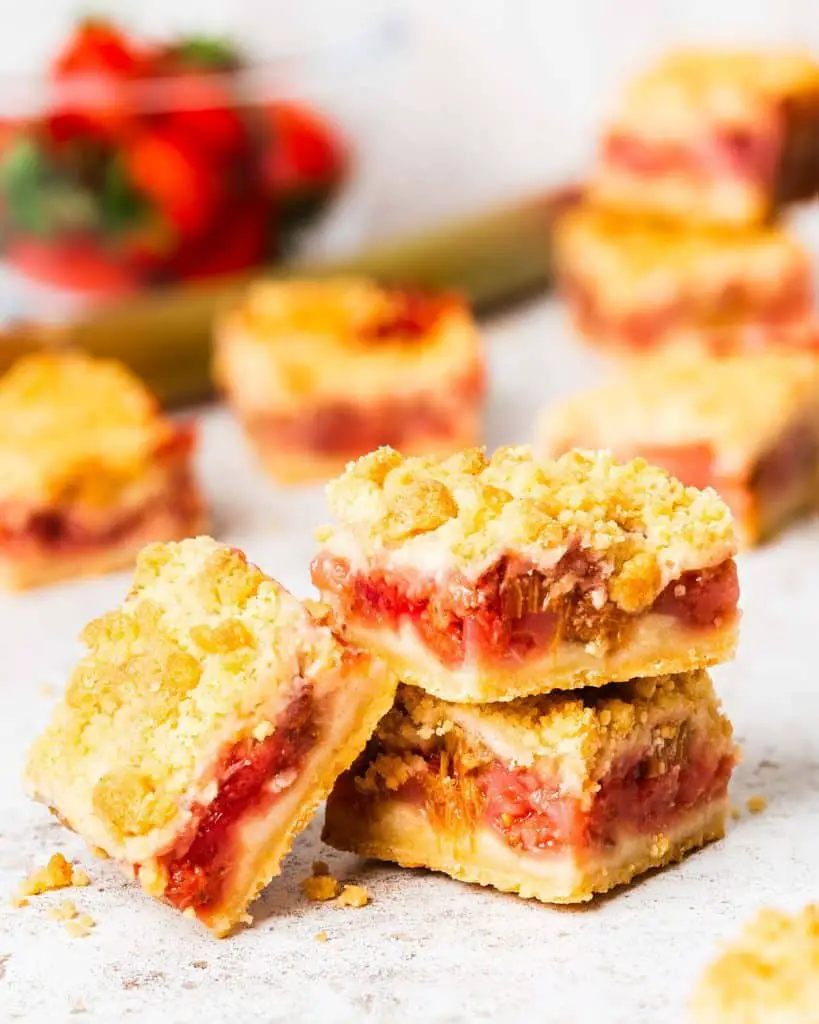 My strawberry rhubarb crumble bars are so incredibly delicious and moreish! A buttery shortbread mixture forms the base and crumble topping, encasing a tart, sweet and vibrant strawberry rhubarb filling. Bake to golden perfection and enjoy! Recipe by movers and bakers
