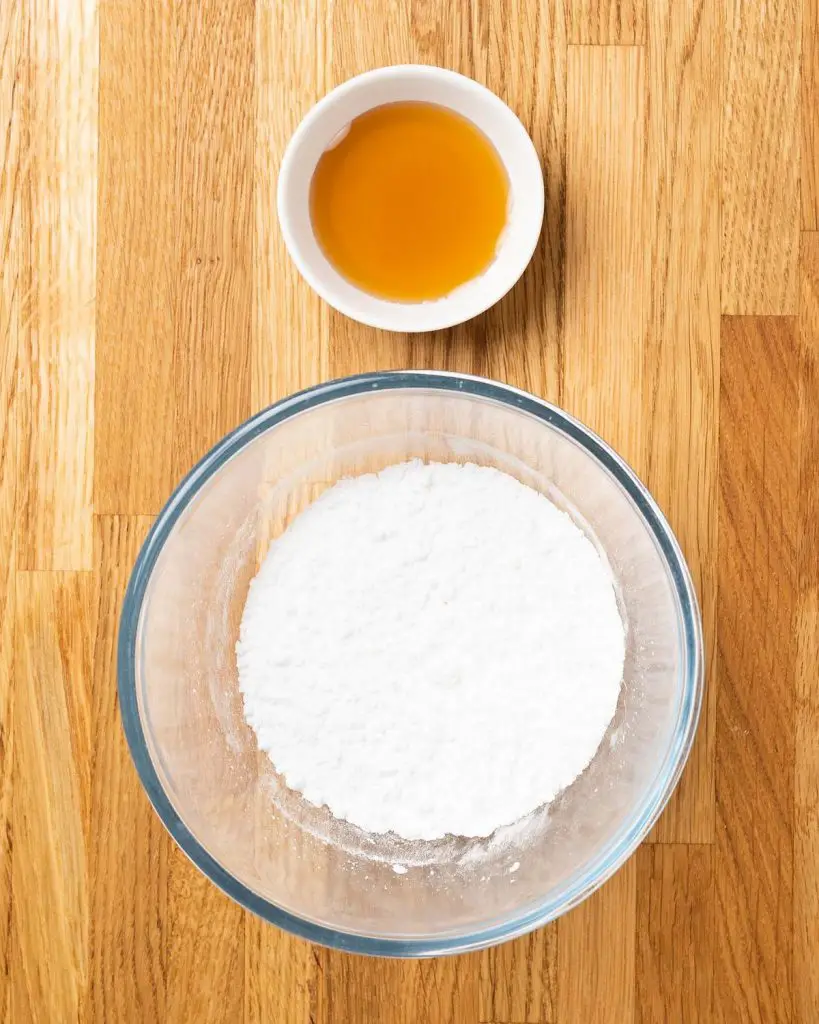 Ingredients for the drizzle: icing (powdered) sugar and maple syrup. Recipe by movers and bakers