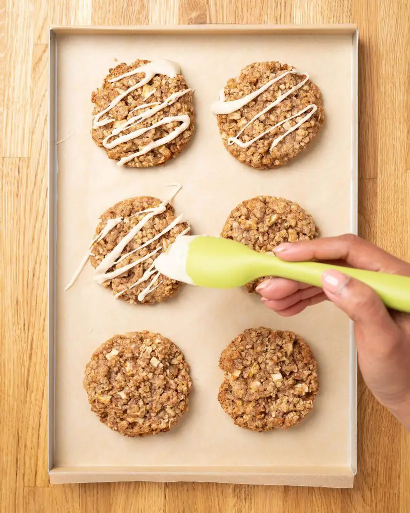 Drizzling the decoration over the baked cookies. Recipe by movers and bakers