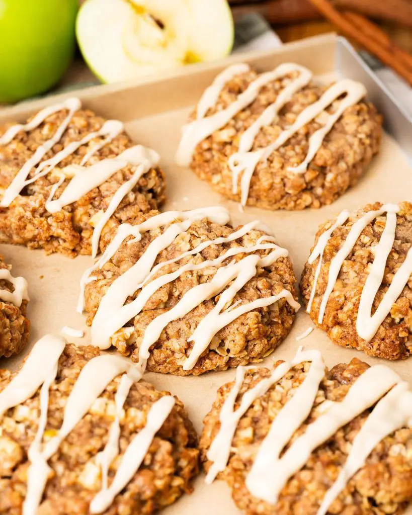 My apple and cinnamon cookies are homely and comforting, with chewy oats and a delicious (optional!) maple drizzle. Recipe by movers and bakers