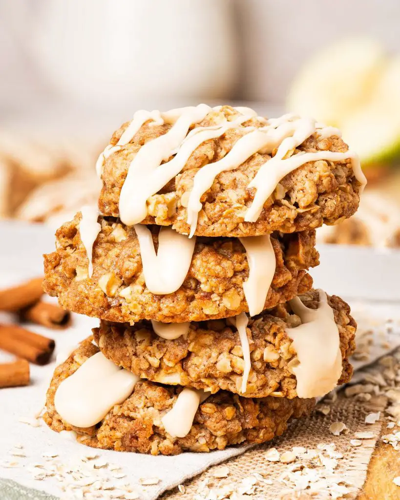 My apple and cinnamon cookies are homely and comforting, with chewy oats and a delicious (optional!) maple drizzle. Recipe by movers and bakers