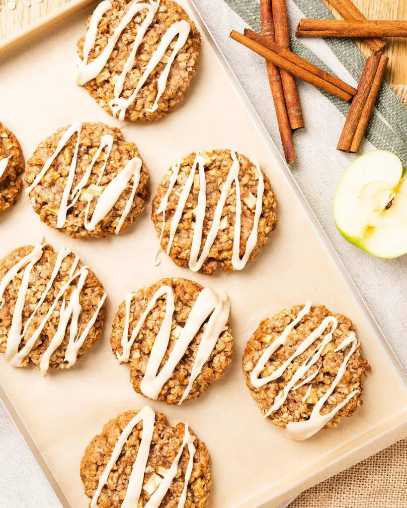 My apple and cinnamon cookies are homely and comforting, with chewy oats and a delicious (optional!) maple drizzle. Recipe by movers and bakers