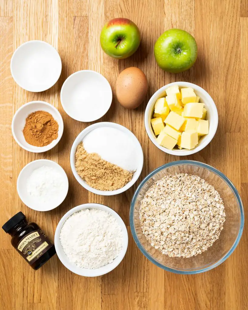 Ingredients required for the cookies: unsalted butter, brown sugar, caster sugar, vanilla, plain (all purpose) flour, cornflour (cornstarch), cinnamon, baking powder, salt, rolled oats, apples and egg. Recipe by movers and bakers