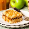 These caramel apple bars have a buttery shortbread base, a delectable cinnamon apple filling and crumbly topping, finished with a beautiful drizzle of caramel. Recipe by movers and bakers