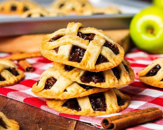 Apple pie cookies have all the joy and delicious cosiness of this homely comfort food, but in a fun cookie instead! Buttery shortcrust pastry, irresistible apple pie filling and a pretty lattice top make these a delight to make and enjoy! Recipe by movers and bakers