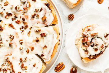 My maple pecan cinnamon rolls are soft and fluffy, packed with plenty of sticky maple pecan filling and topped with a delicious maple cream cheese glaze. Yum! Recipe by movers and bakers