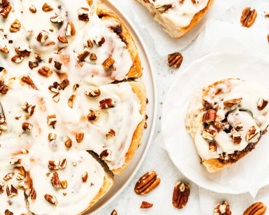 My maple pecan cinnamon rolls are soft and fluffy, packed with plenty of sticky maple pecan filling and topped with a delicious maple cream cheese glaze. Yum! Recipe by movers and bakers