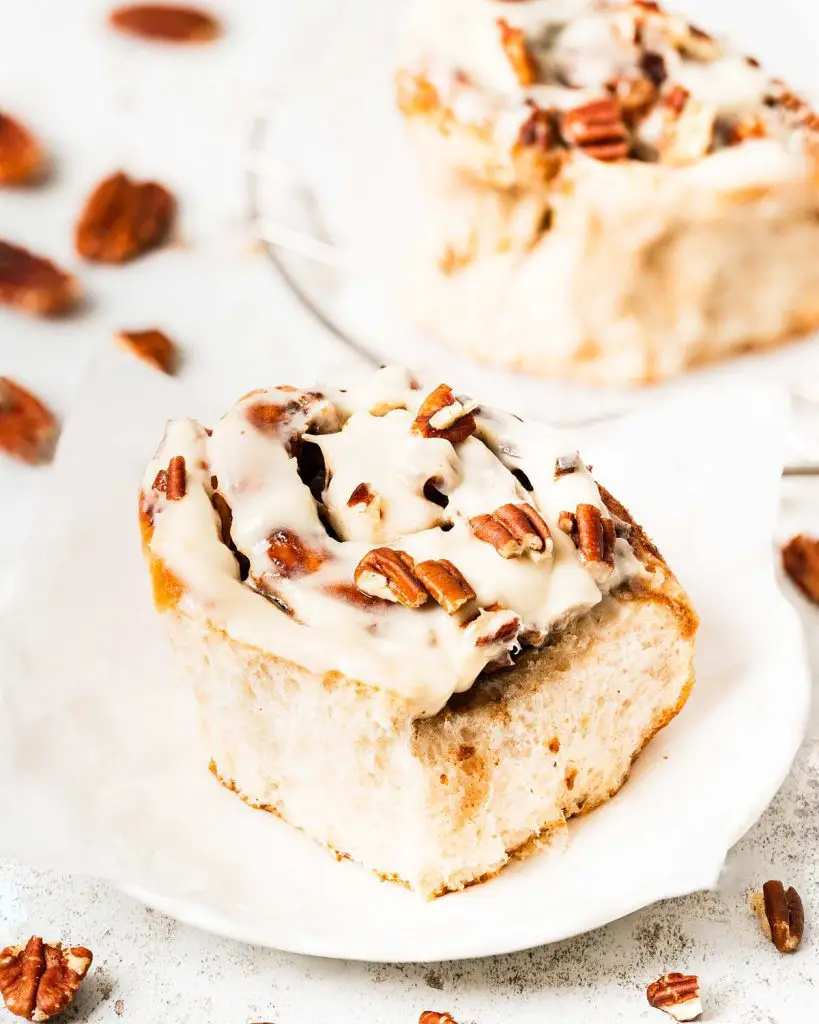 My maple pecan cinnamon rolls are soft and fluffy, packed with plenty of sticky maple pecan filling and topped with a delicious maple cream cheese glaze. Yum! Recipe by movers and bakers