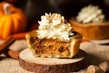 My mini pumpkin pies have a thin buttery shortcrust pastry shell and a deliciously autumnal pumpkin pie filling. Topped with a swirl of whipped cream and dusted with pumpkin spice, this is one dessert everyone will love! Recipe by movers and bakers