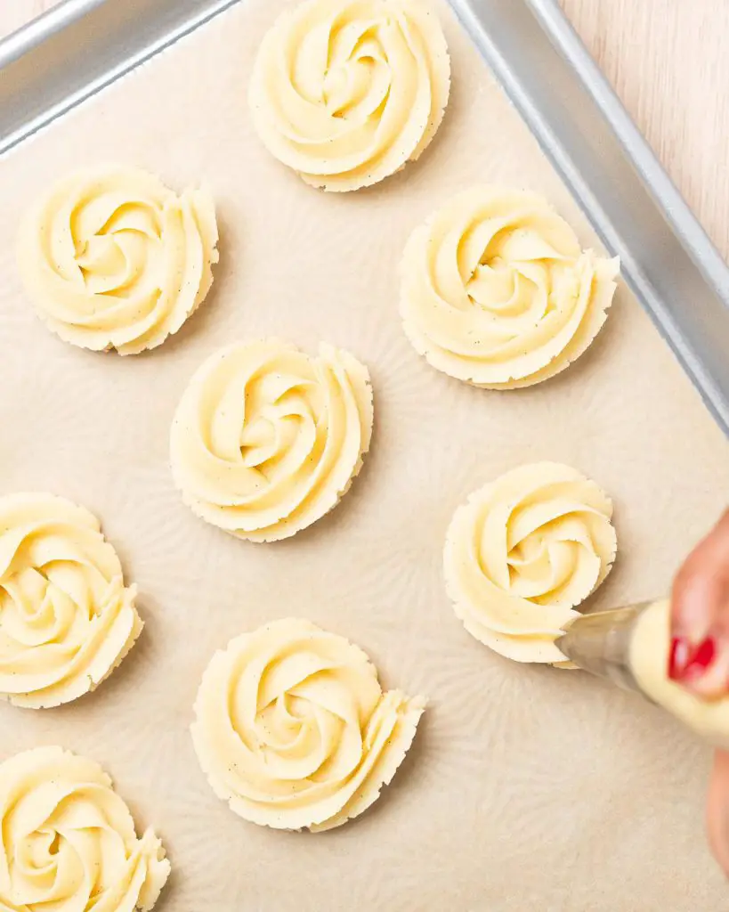 Pipe the dough into rosettes before freezing to firm up and baking. Recipe by movers and bakers