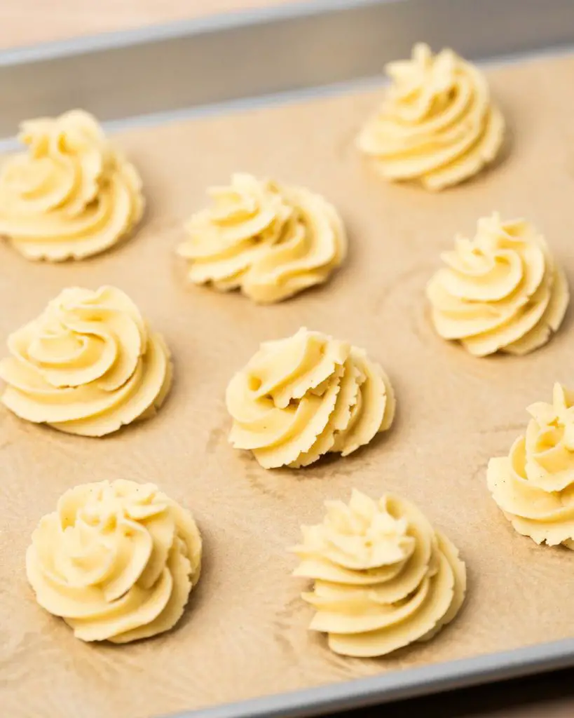 Piped swirls are chilled before baking to help them hold their shape. Recipe by movers and bakers