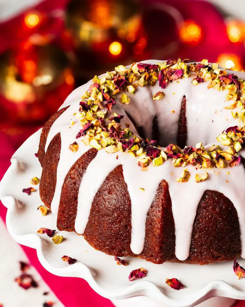 My gulab jamun cake is moist and flavourful and so utterly irresistible! It has an eggless cardamom cake, a deep cardamom and rose water syrup and a pretty pink glaze decorated with chopped pistachios and dried rose petals. The prettiest celebration cake! Recipe by movers and bakers