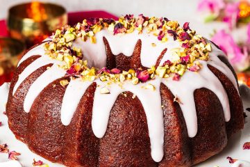 My gulab jamun cake is moist and flavourful and so utterly irresistible! It has an eggless cardamom cake, a deep cardamom and rose water syrup and a pretty pink glaze decorated with chopped pistachios and dried rose petals. The prettiest celebration cake! Recipe by movers and bakers