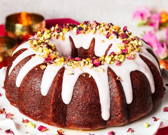 My gulab jamun cake is moist and flavourful and so utterly irresistible! It has an eggless cardamom cake, a deep cardamom and rose water syrup and a pretty pink glaze decorated with chopped pistachios and dried rose petals. The prettiest celebration cake! Recipe by movers and bakers
