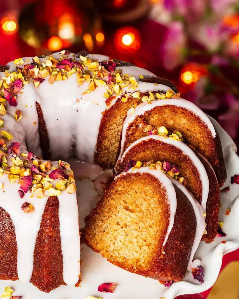 My gulab jamun cake is moist and flavourful and so utterly irresistible! It has an eggless cardamom cake, a deep cardamom and rose water syrup and a pretty pink glaze decorated with chopped pistachios and dried rose petals. The prettiest celebration cake! Recipe by movers and bakers