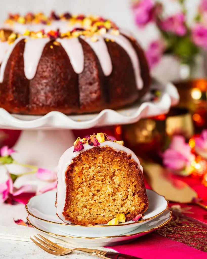 My gulab jamun cake is moist and flavourful and so utterly irresistible! It has an eggless cardamom cake, a deep cardamom and rose water syrup and a pretty pink glaze decorated with chopped pistachios and dried rose petals. The prettiest celebration cake! Recipe by movers and bakers