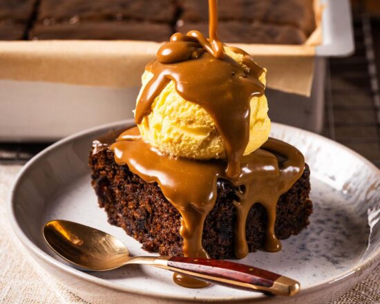 Sticky toffee pudding is a British classic dessert. It has a rich dark date sponge and a gloriously decadent toffee sauce. Enjoy warm with ice cream, cream or custard. Recipe by movers and bakers