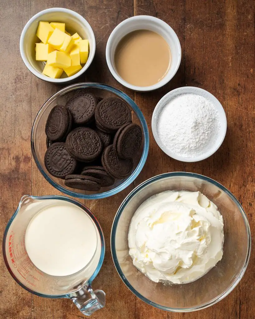 Ingredients required for the cheesecake: cookies and cream biscuits, unsalted butter, cream cheese, double (heavy) cream, icing (powdered) sugar, and Baileys. Recipe by movers and bakers