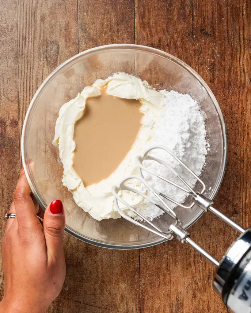 Mixing together the cream cheese, icing (powdered) sugar and Baileys....