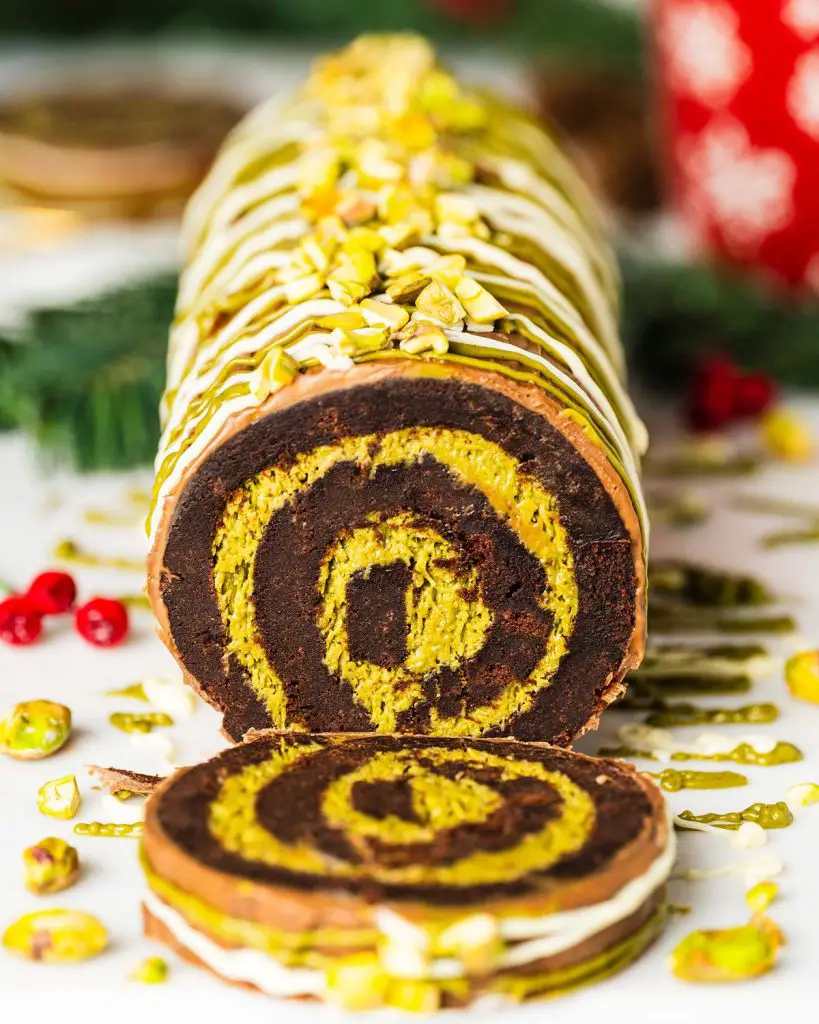 My viral Dubai chocolate brownie yule log has a soft and squidgy brownie layer swirled with a pistachio kataifi filling. Topped with milk chocolate and decorated with a chocolate and pistachio drizzle, this gorgeous dessert is sure to wow all your guests! Recipe by movers and bakers