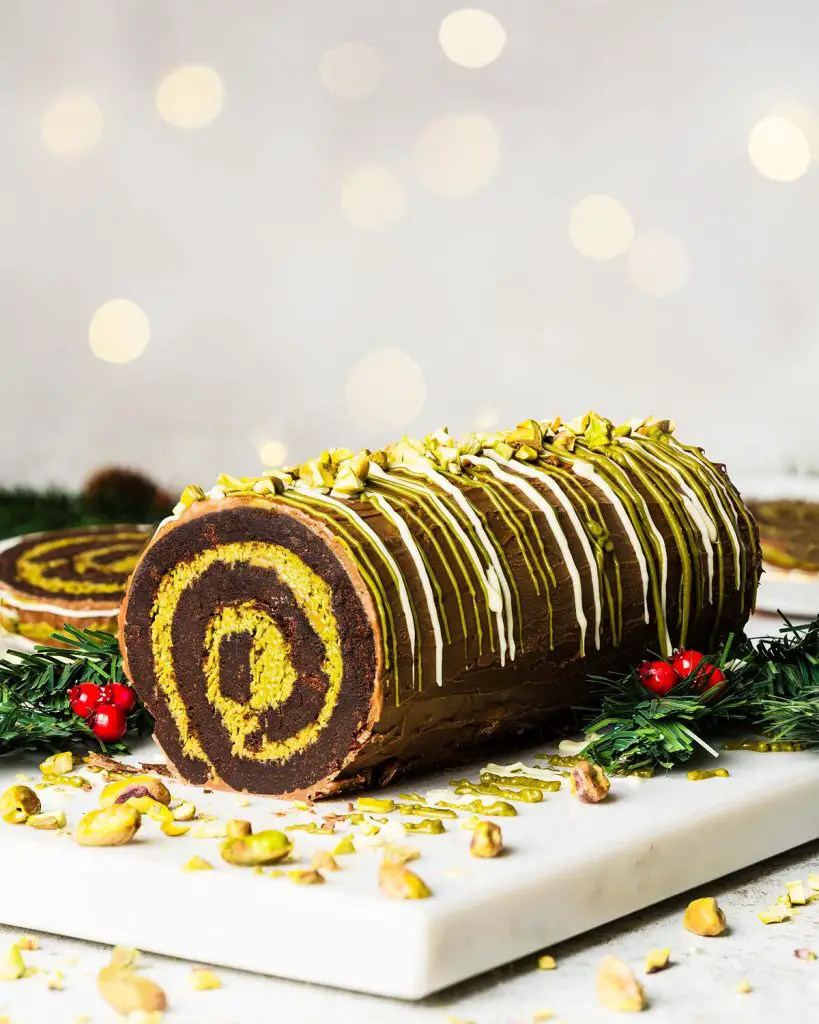 My viral Dubai chocolate brownie yule log has a soft and squidgy brownie layer swirled with a pistachio kataifi filling. Topped with milk chocolate and decorated with a chocolate and pistachio drizzle, this gorgeous dessert is sure to wow all your guests! Recipe by movers and bakers