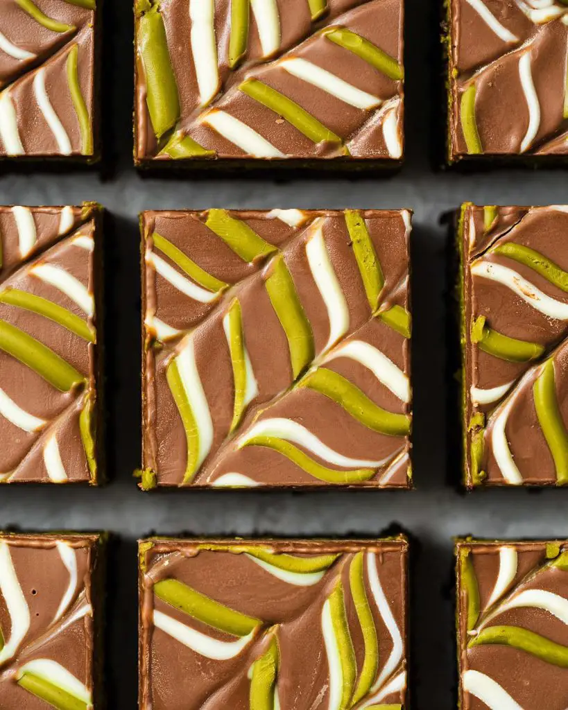 My viral Dubai pistachio chocolate brownies are just so good! With a chewy brownie base, a crunchy pistachio kunafe filling and a pretty feathered chocolate layer to finish, these beautiful squares of joy are really hard to resist! Recipe by movers and bakers