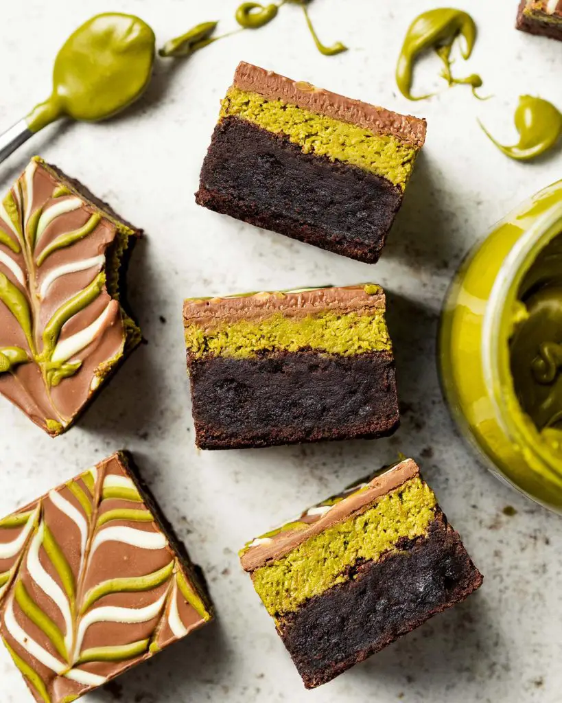 My viral Dubai pistachio chocolate brownies are just so good! With a chewy brownie base, a crunchy pistachio kunafe filling and a pretty feathered chocolate layer to finish, these beautiful squares of joy are really hard to resist! Recipe by movers and bakers