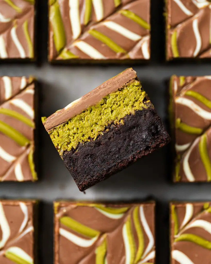 My viral Dubai pistachio chocolate brownies are just so good! With a chewy brownie base, a crunchy pistachio kunafe filling and a pretty feathered chocolate layer to finish, these beautiful squares of joy are really hard to resist! Recipe by movers and bakers