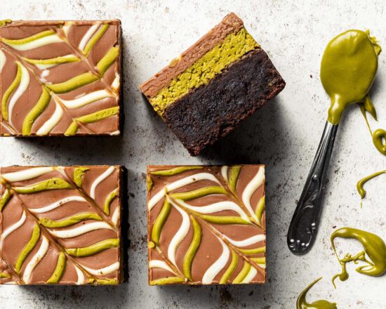 My viral Dubai pistachio chocolate brownies are just so good! With a chewy brownie base, a crunchy pistachio kunafe filling and a pretty feathered chocolate layer to finish, these beautiful squares of joy are really hard to resist! Recipe by movers and bakers