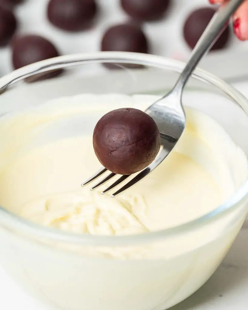 Use a fork to carefully dip each truffle into the melted chocolate...