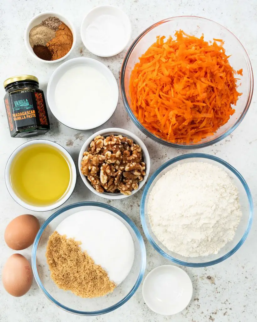 Ingredients for the cake: oil, buttermilk, caster sugar, brown sugar, vanilla, eggs, carrots, plain (all purpose) flour, baking powder, bicarbonate of soda (baking soda), salt, spices and walnuts. Recipe by movers and bakers