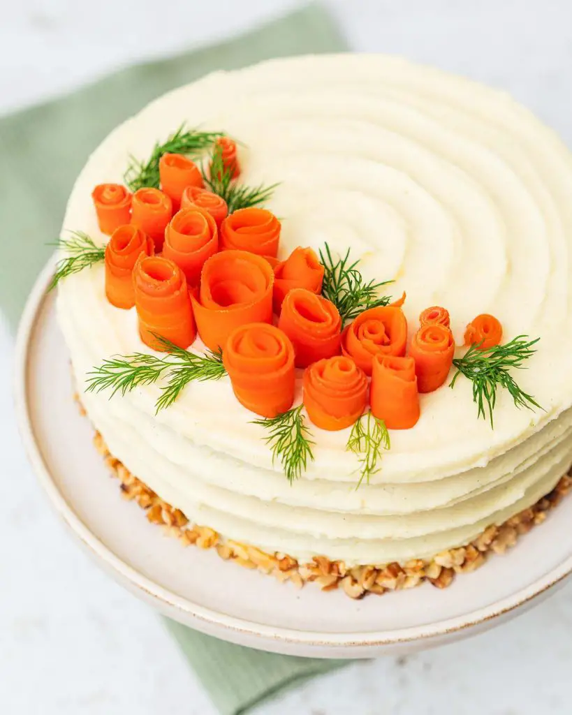 Finished and decorated and ready to serve! Delicious carrot cake that everyone will love! Recipe by movers and bakers