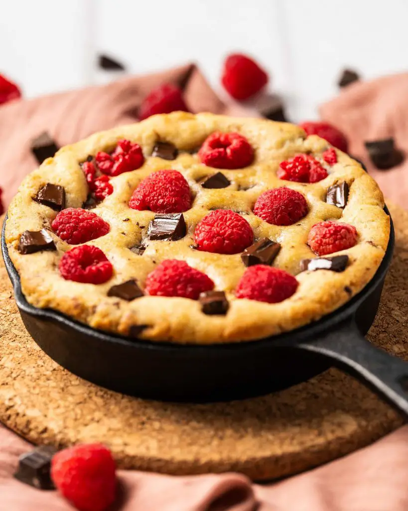 My dark chocolate raspberry skillet cookie is a delightful simple dessert for two. Perfect for Valentines, Galentines, a special anniversary or just because, everyone loves this dessert! Recipe be movers and bakers