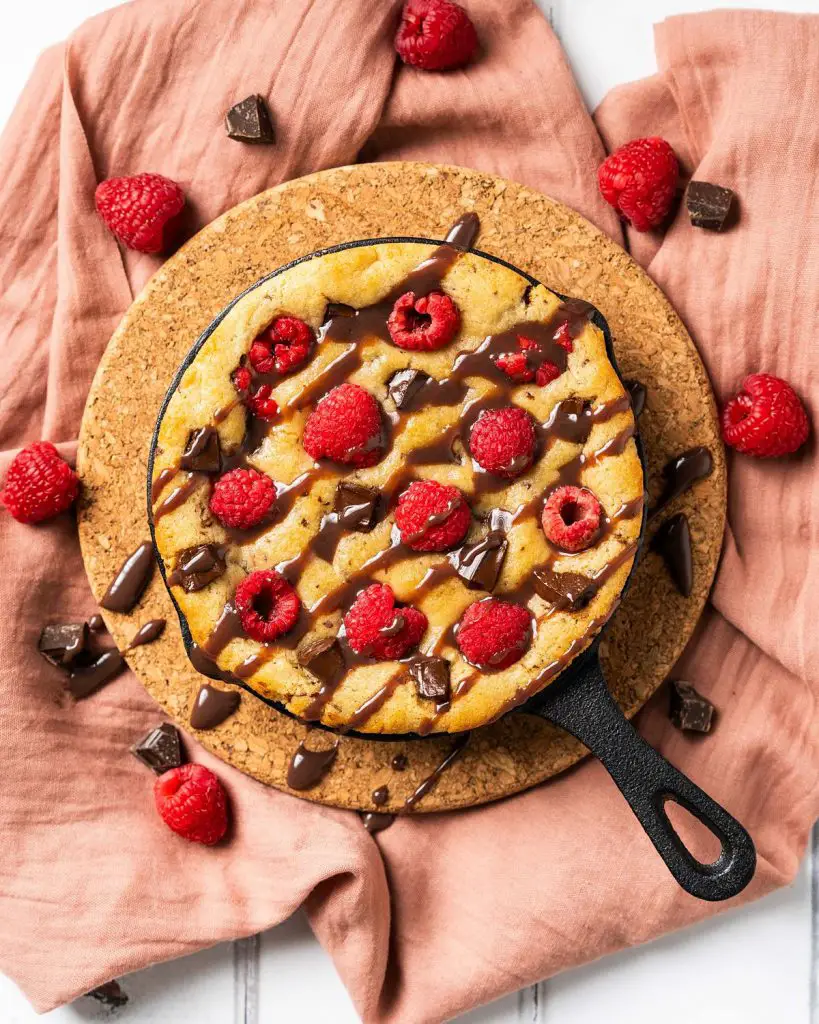 My dark chocolate raspberry skillet cookie is a delightful simple dessert for two. Perfect for Valentines, Galentines, a special anniversary or just because, everyone loves this dessert! Recipe be movers and bakers