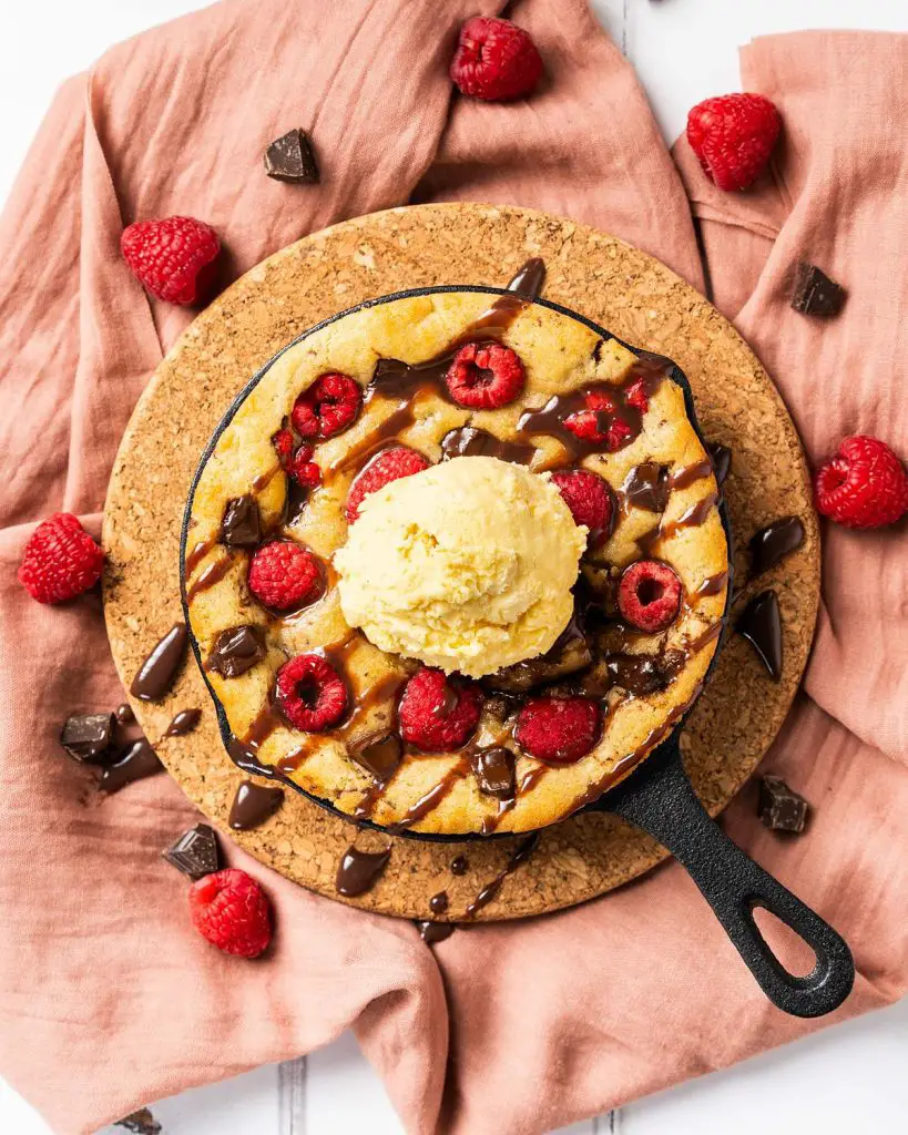 My dark chocolate raspberry skillet cookie is a delightful simple dessert for two. Perfect for Valentines, Galentines, a special anniversary or just because, everyone loves this dessert! Recipe be movers and bakers