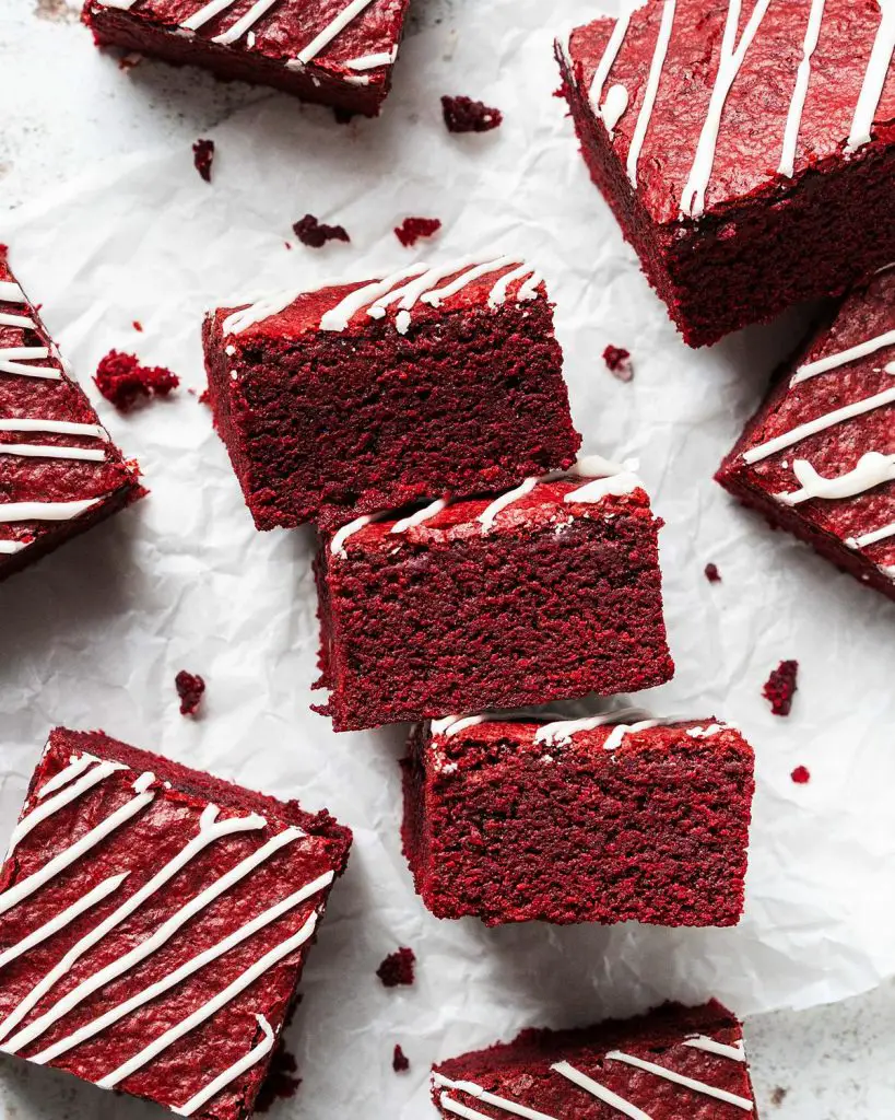 My red velvet brownies are fudgy and chewy, with a perfectly balance flavour, and topped with a scrumptious cream cheese drizzle. Recipe by movers and bakers