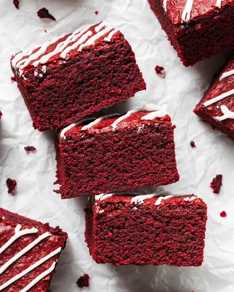 My red velvet brownies are fudgy and chewy, with a perfectly balance flavour, and topped with a scrumptious cream cheese drizzle. Recipe by movers and bakers