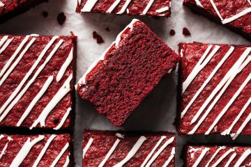 My red velvet brownies are fudgy and chewy, with a perfectly balance flavour, and topped with a scrumptious cream cheese drizzle. Recipe by movers and bakers